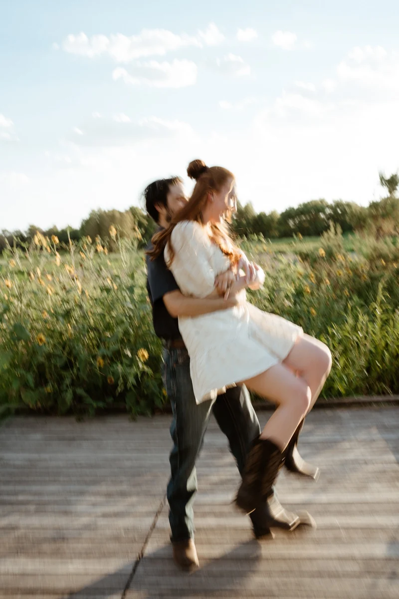 Abby jumping into Collin's arms on the boardwalk