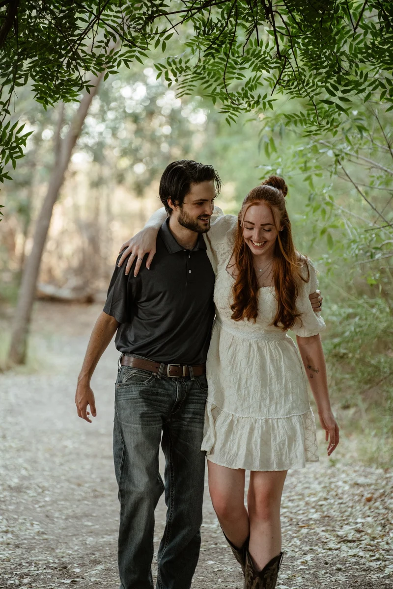 Abby and Collin smiling on a walk at golden hour