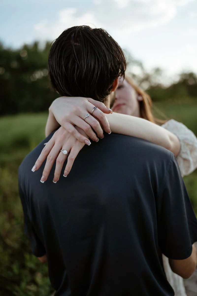 Abby's arms wrapped around Collin's shoulders